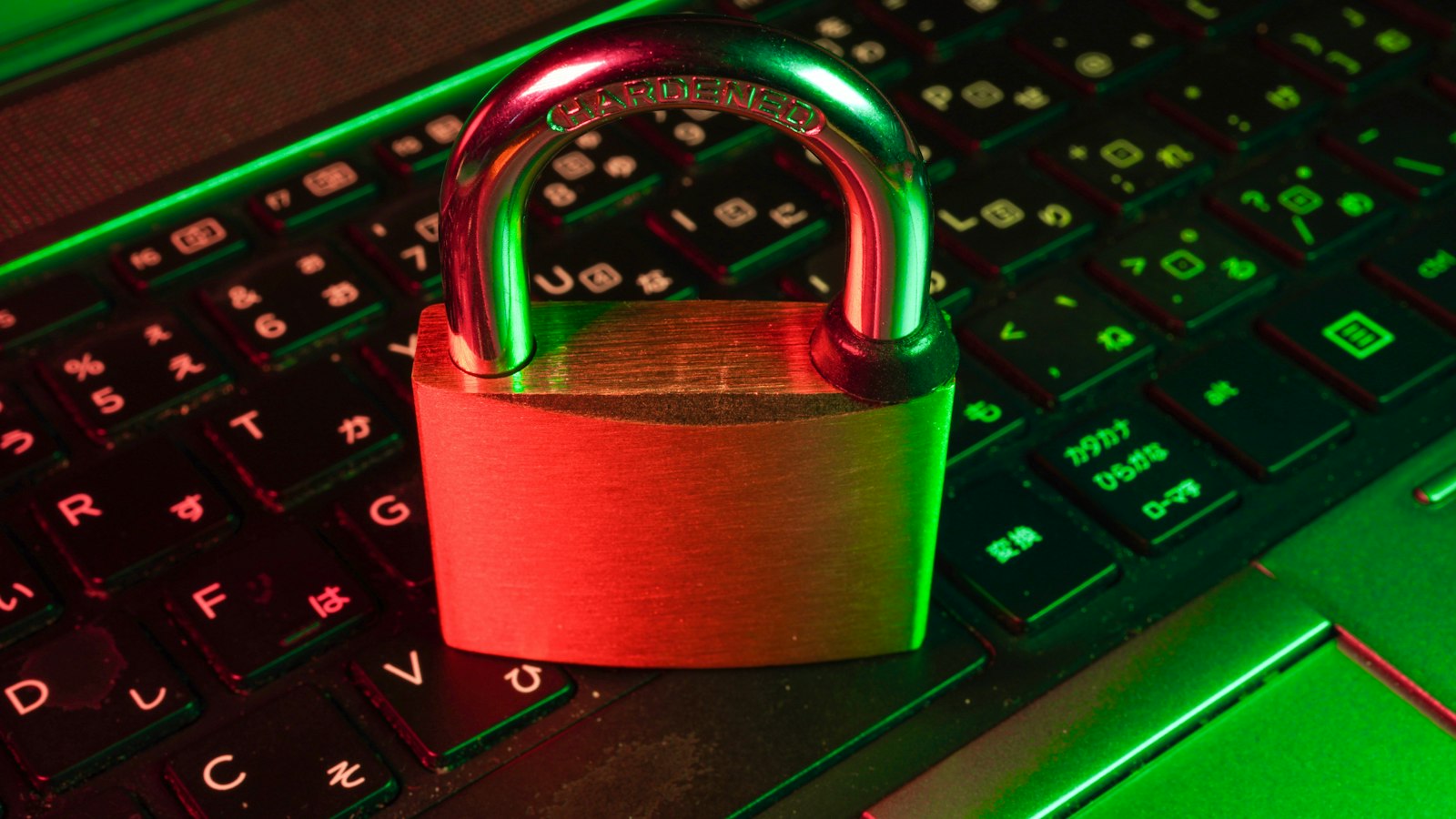 A padlock resting on a backlit computer keyboard